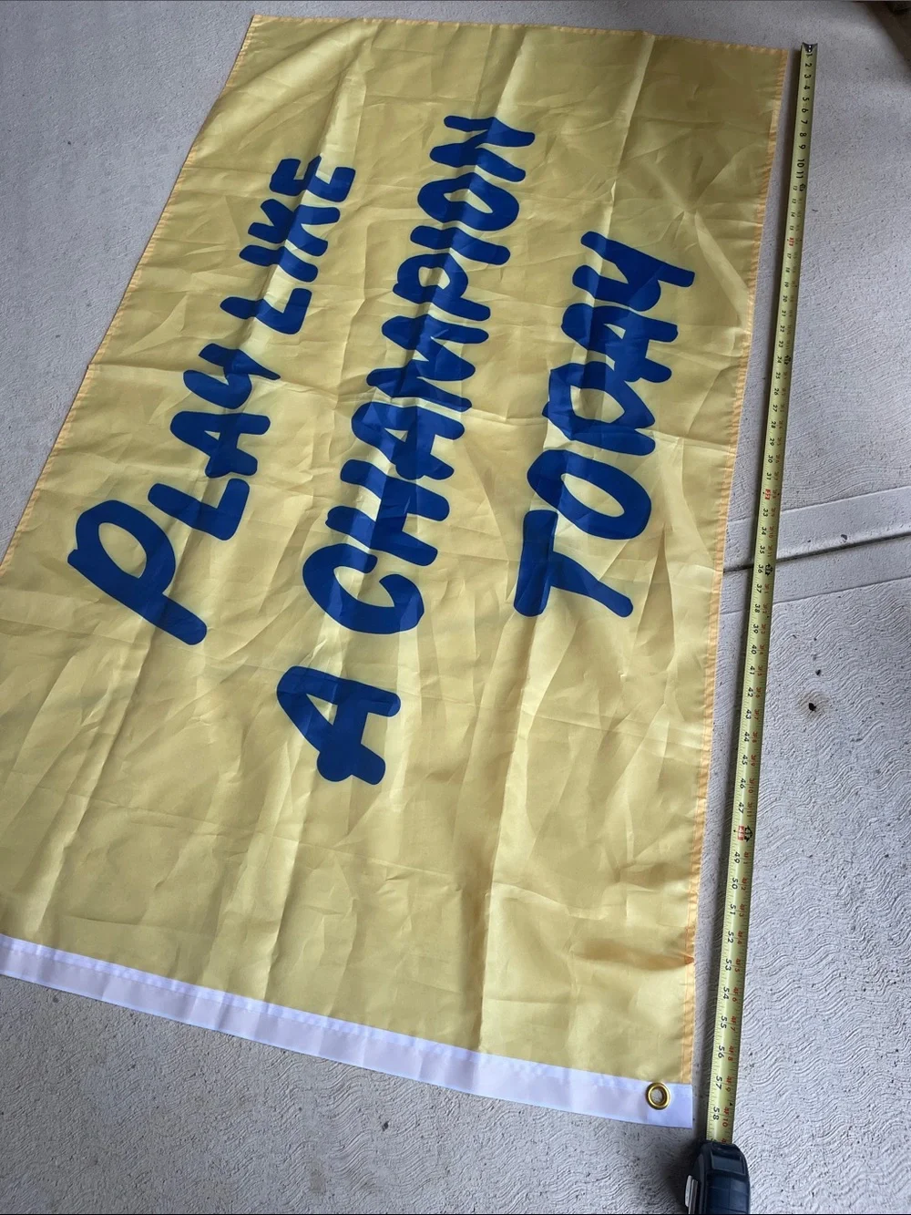 Play Like a Champion Today Yellow Banner with Blue Lettering and Grommet